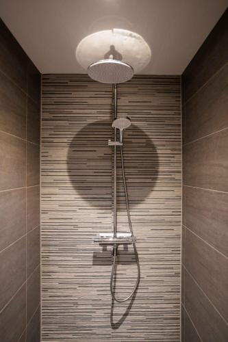 a shadow of a shower head in a bathroom at Happy 1 Bedroom Apartment - WE39C in Tiel