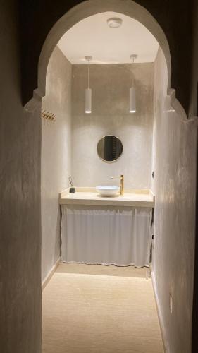 a bathroom with a sink and a shower curtain at Riad Jonan & Spa in Marrakech
