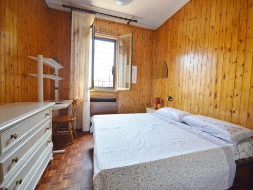 a bedroom with a bed and a desk and a window at Piana, Bologna by Short Holidays in Bologna