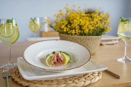 a plate of food on a table with wine glasses at Villa Capparis in Moírai