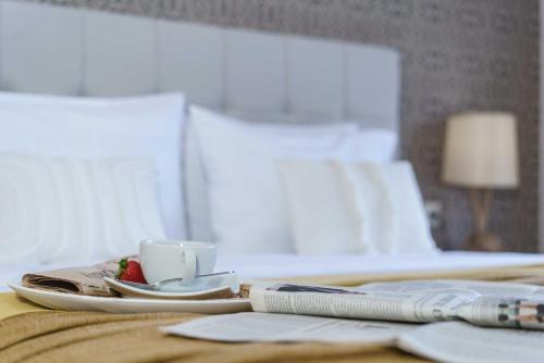 a table with a coffee cup on a bed at Villa Capparis in Moírai