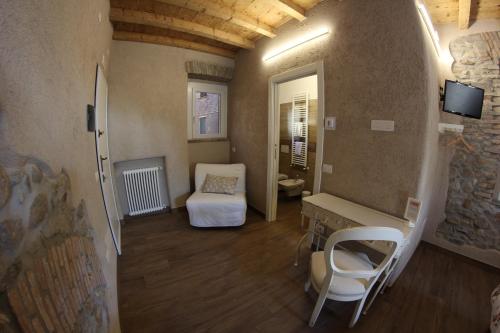 a room with a bedroom with a bed and a desk at Locanda Vecchia Osteria in Varese