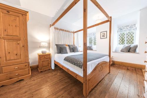 a bedroom with a four poster canopy bed at Potter's Wheel in High Nibthwaite