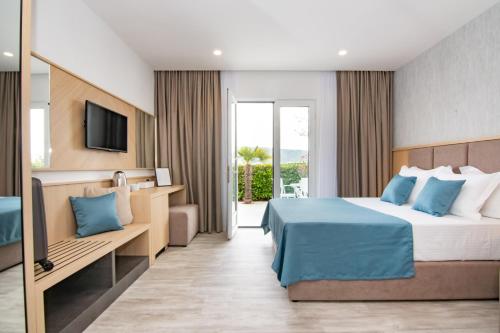 a hotel room with a bed and a television at Hotel Perla - Annexes in Herceg-Novi
