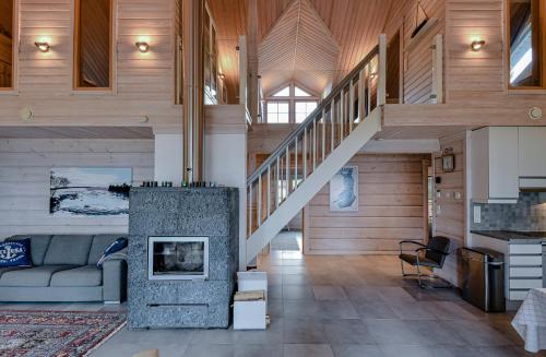a living room with a couch and a staircase at Aava Koli in Kolinkylä