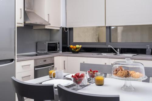 a kitchen with a table with a bowl of food on it at Zen Central Luxury Apartment in Heraklio