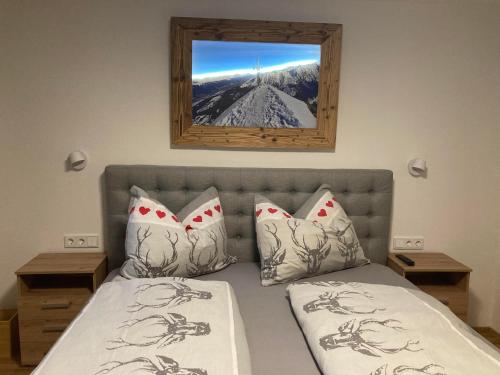 a bedroom with a bed with a view of a mountain at Appartement Stefanie in Hollersbach im Pinzgau