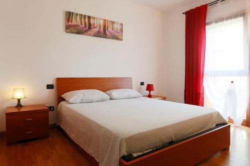 een slaapkamer met een bed en een rood gordijn bij Quercegrossa 10 in Quercegrossa
