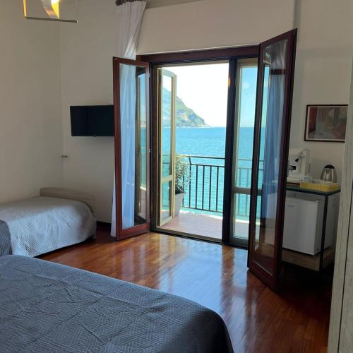 a bedroom with a bed and a view of the ocean at Vip sul mare in Castellammare di Stabia