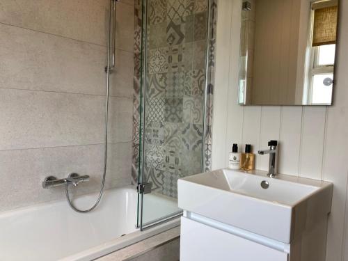 a bathroom with a shower and a sink and a shower at The Old Bell B&B in Grimston