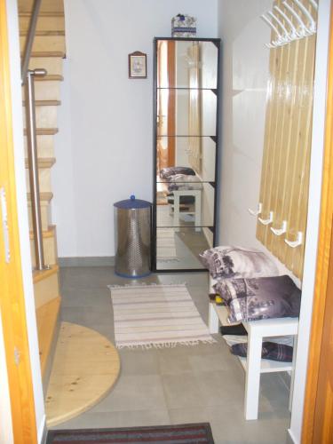 a hallway with a dressing room with a mirror at Berta Apartman in Senta