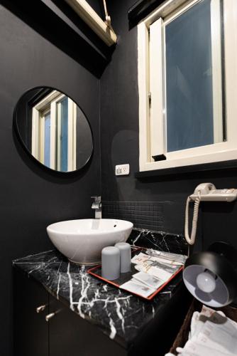 a bathroom with a sink and a mirror at 沐-湯宿溫泉行旅 in Jiaoxi