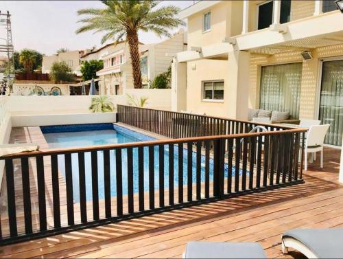 a balcony with a swimming pool on a house at Villa Glamour Eilat family only in Eilat