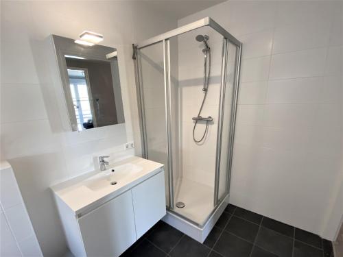 a bathroom with a shower and a sink at Caramia, Duinhof, Romantic apartment by the sea in Cadzand-Bad