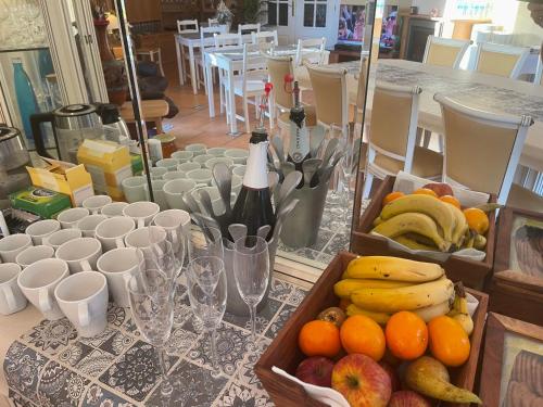 a table with a tray of fruit and a bottle of wine at Anna's garden in Torrevieja