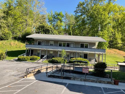 a house with a parking lot in front of it at Carr's Northside Hotel and Cottages in Gatlinburg