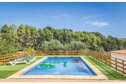 a swimming pool in a yard with a fence at Ca l'Antoni in Avinyonet