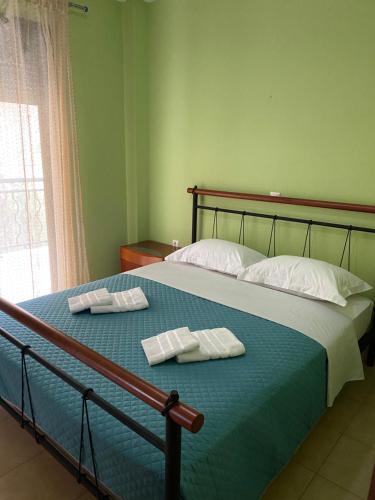 a bedroom with a bed with two towels on it at Nea Skioni apartment in Nea Skioni