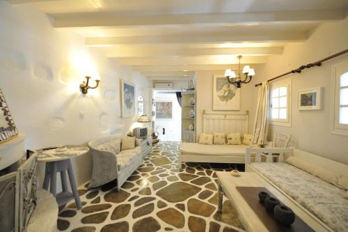 a large living room with a couch and a table at Blue Bay Heliolithos in Parikia