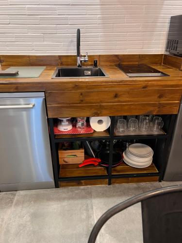 eine Küche mit einer Spüle und einer Theke mit Tellern in der Unterkunft Alojamientos Rías Baixas - Mares del Forte- Cangas in Cangas