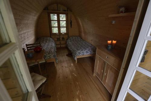 an attic room with two beds and a window at Campingpod back to basic in Tønder
