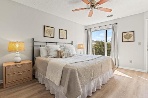 a bedroom with a bed and a ceiling fan at Sun of a Beach in Manteo