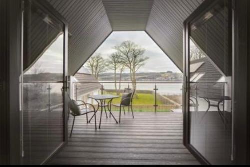a view of a porch with a table and chairs at Little Gleddoch in Dumbarton