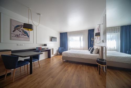 Ένα ή περισσότερα κρεβάτια σε δωμάτιο στο RESIDENCE Rive Droite