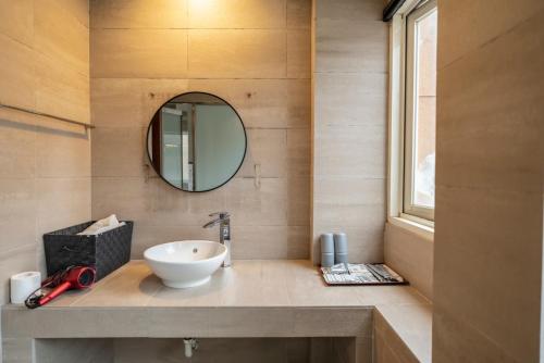 a bathroom with a sink and a mirror at 沐-湯宿溫泉行旅 in Jiaoxi