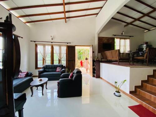a living room with two couches and a table at Pearl's Homestay Matale in Matale
