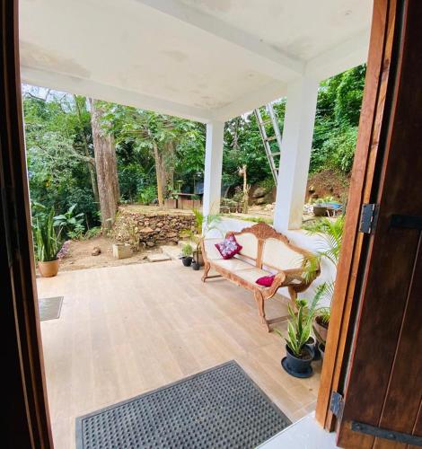 an open door to a porch with a couch at Pearl's Homestay Matale in Matale