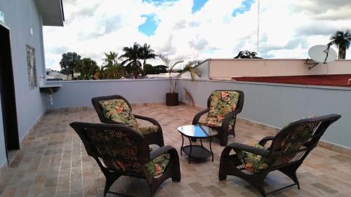 a group of chairs and a table on a balcony at HOTEL VIZON II in Vilhena