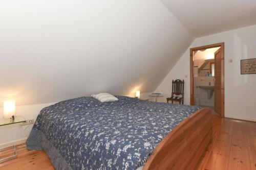 BorgsumにあるHüs an den Salzwiesenのベッドルーム1室(青い掛け布団付きのベッド1台付)