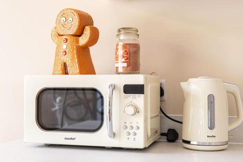 a microwave with a gingerbread man on top of it at Gingerbread Lodge in Torquay