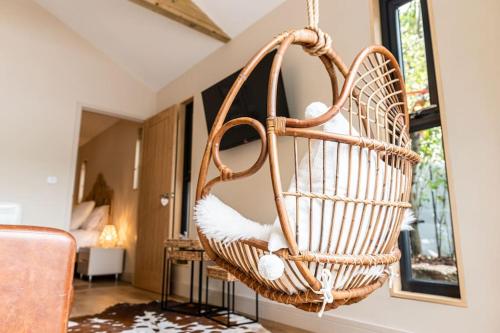 a wicker basket hanging from a wall in a living room at NEW Gingerbread Lodge of Tranquility in Torquay