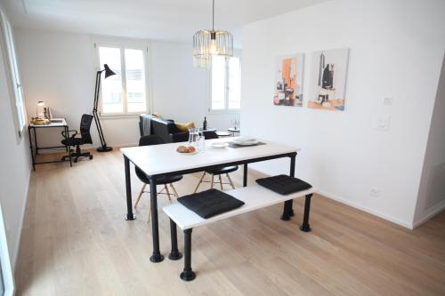 a living room with a table and a chair at Nest - Kanzleistrasse 217 in Zurich