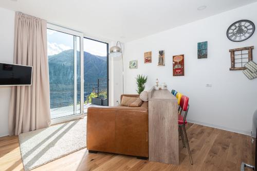 - un salon avec un canapé et une grande fenêtre dans l'établissement Appartamento Dany con vista lago, à Nesso
