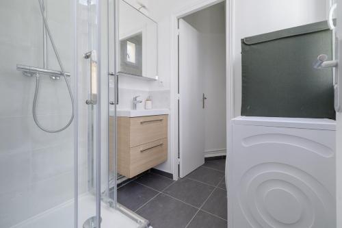 a bathroom with a shower and a toilet and a sink at Bridgestreet Le Marais - les halles in Paris