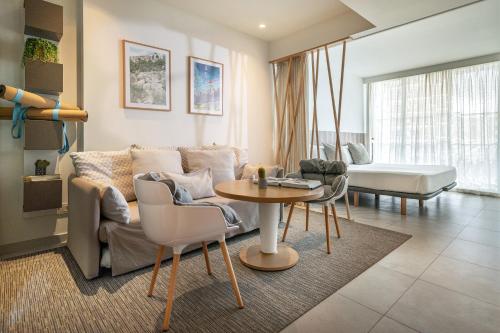 a living room with a couch and a table at INNSiDE by Meliá Calviá Beach in Magaluf