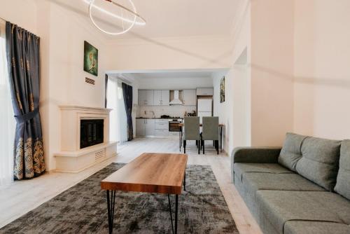 a living room with a couch and a table at Luxuriant Houses Kyrenia in Kérynia