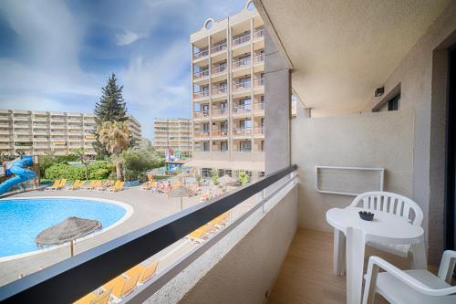 a balcony with a view of a pool and a resort at Ohtels Belvedere in Salou