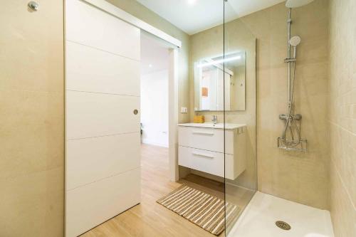 a bathroom with a glass shower and a sink at Sur Suites Palmeras 9 in Fuengirola