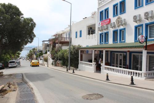 a city street with a yellow car driving down the street at İZAN VİLLA BAKIŞ APARTMENTS in Bodrum City