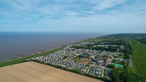 an aerial view of a parking lot next to the ocean at 8 Berth Caravan With Decking And Wifi At Broadland Sands Park Ref 20064Cf in Hopton on Sea