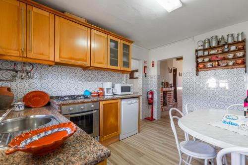 a kitchen with a sink and a table at Casa da Varzinha in A dos Cunhados