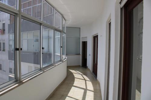 a corridor of a building with glass windows at João Paulo II Apartment in Fátima