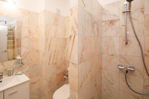 a bathroom with a shower and a toilet and a sink at Windmill by OCvillas in Albufeira