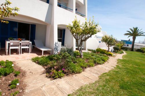 a house with a patio and a table in a yard at Windmill by OCvillas in Albufeira
