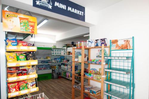 a store aisle with toys and other items on shelves at Windmill by OCvillas in Albufeira