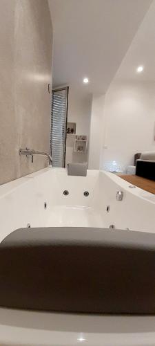 a large white bath tub in a room at BARBARA Classy Apartments 103, Wellness in Siracusa
